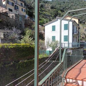 a balcony with a white building and a house at Fontantica di Vernazza in Vernazza