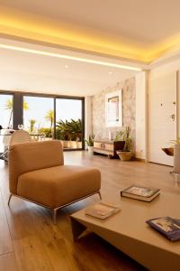 a living room with a couch and a table at Maison de Charme Taormina with private jacuzzi in Taormina
