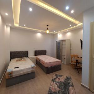 a room with two beds and a couch and a table at Egy property in 6th Of October