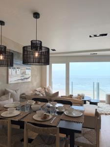 a living room with a table and a couch at NEPTUNE Wenduine met zeezicht - VOSPROPERTIES in Wenduine