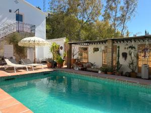 a swimming pool in front of a house at Casa Tragabalas in Cómpeta