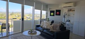 a living room with a couch and a table at Ocean Retreat in Yeppoon