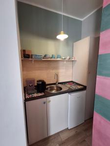 a small kitchen with a sink and a counter at Nel borgo San Francesco in Montesarchio