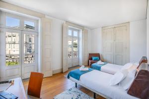 a living room with two beds and a couch at HI Guimaraes - Pousada de Juventude in Guimarães +59 photos