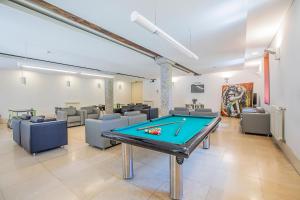 a gaming room with a pool table and couches at HI Guimaraes - Pousada de Juventude in Guimarães