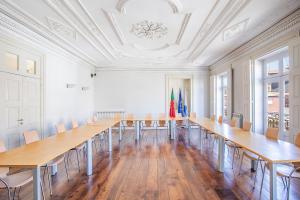 a large room with a long table and chairs at HI Guimaraes - Pousada de Juventude in Guimarães
