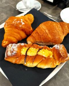 a plate of pastries and croissants on a table at Nevè central - Apartment in Civitavecchia +12 photos