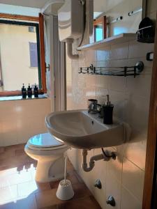 a bathroom with a sink and a toilet at Affascinante Mansarda nel Cuore di Brunate in Brunate