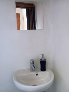 a white sink in a bathroom with a mirror at Affascinante Mansarda nel Cuore di Brunate in Brunate +18 photos