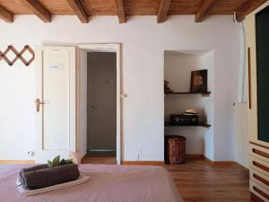 a bedroom with a bed and a door to a hallway at Affascinante Mansarda nel Cuore di Brunate in Brunate