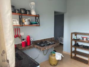 a kitchen with a counter and a stove in a room at Ape Bianck's in Ilha Comprida +1 photo