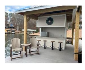 a patio with a kitchen and two chairs and a table at Wake N Lake in Littleton
