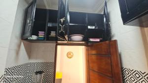 a hallway with a door with a shelf above it at Luxury lita Résidence in Yaoundé +17 photos