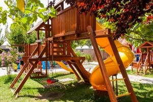 a playground with a tree house and a slide at Cross Apartments and Tours in Yerevan