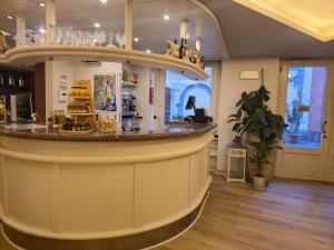 a restaurant with a counter in a room at Alle Porte in Riva del Garda
