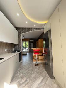 a kitchen with white cabinets and a red stool at Padova in Cedro in Padova