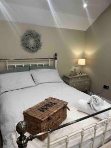 a bedroom with a bed with a basket on it at 86 Galgorm in Ballymena