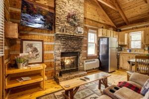 a living room with a fireplace and a refrigerator at Bearadise in Townsend