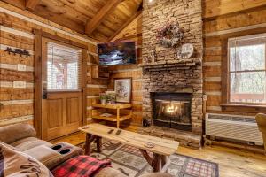 a living room with a fireplace in a log cabin at Bearadise in Townsend