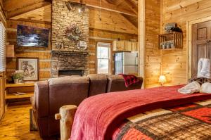 a bedroom with a couch and a stone wall at Bearadise in Townsend +26 photos