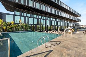 a swimming pool in front of a building at Axis Viana Business & SPA Hotel in Viana do Castelo