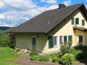 a house with a black roof and green shutters at Ferienhof Oldach in Bacharach