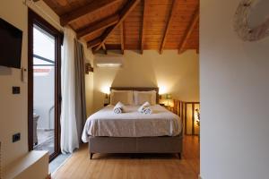 a bedroom with a bed with two towels on it at Hidden Petra Luxury Suites 2 in Ialysos