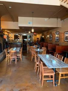 a restaurant with wooden tables and chairs and a bar at Iron Horse Station in Hot Springs +21 photos
