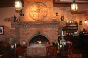 a brick fireplace in a restaurant with tables and chairs at Iron Horse Station in Hot Springs