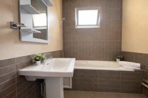 a bathroom with a sink and a bath tub at Magnifique appartement 3 pièces à Hydra in Hydra