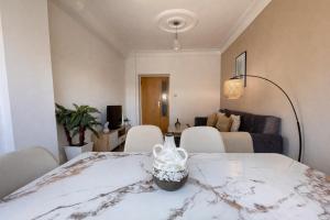 a room with a table and chairs and a couch at Magnifique appartement 3 pièces à Hydra in Hydra +17 photos