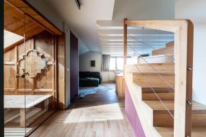 a room with a bunk bed and a staircase at Cesa del Volp in Canazei