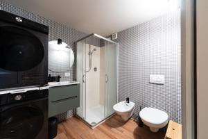 a bathroom with a shower and a toilet and a sink at Cesa del Volp in Canazei +19 photos