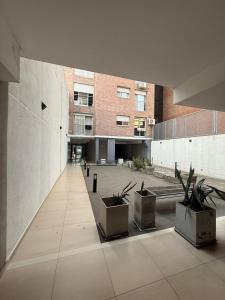 a large building with a courtyard with potted plants at Studio Roca in Rosario