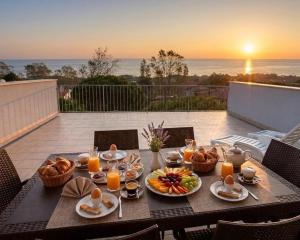 a table with food on it with a view of the ocean at Residence Alessandro a pochi passi dalla spiaggia in Rosolina Mare