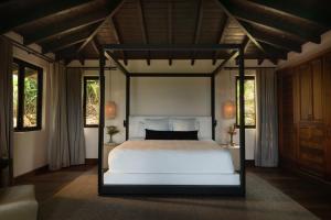 a bedroom with a bed and two windows at Royal Isabela in Isabela