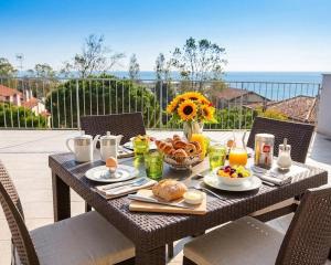a table with breakfast food on top of a balcony at Residence Alessandro a pochi passi dalla spiaggia in Rosolina Mare