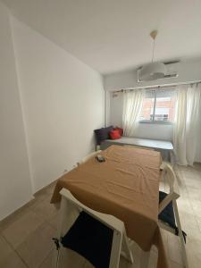 a room with a bed and a table in it at Studio Roca in Rosario
