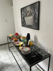 a table with plates and wine glasses on it at its hotel in Itapetinga