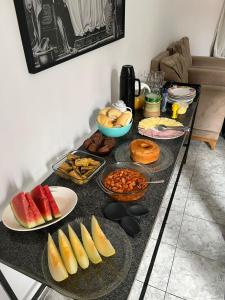 a table topped with plates of food on a counter at its hotel in Itapetinga +5 photos
