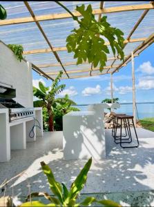 a patio with a table and a view of the ocean at Casa Del Mare Ocean SeaView Villa with Private Pool in Zanzibar City +13 photos