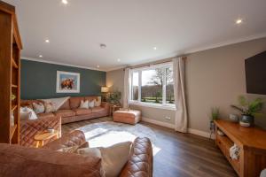 a living room with two couches and a television at Cuilreigh, North Connel in Oban