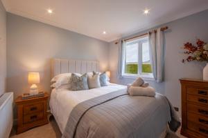 a bedroom with a large bed with a window at Cuilreigh, North Connel in Oban