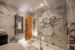 a bathroom with a shower and a sink and a tub at Cuilreigh, North Connel in Oban +46 photos
