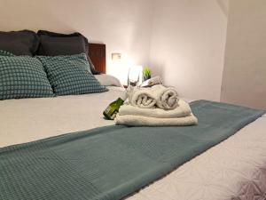 a bedroom with a bed with a towel on it at Casa cubo in Alhama de Granada