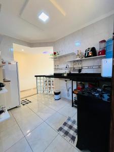 a kitchen with a counter top in a room at Casa Amarela de Praia in Maricá