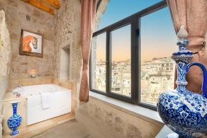 a bathroom with a large vase sitting next to a window at Megaron Cave Hotel Cappadocia in Ortahisar +32 photos