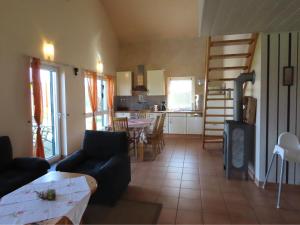 a living room with a couch and a table and a kitchen at Ferienhof Oldach in Bacharach