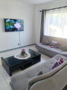 a living room with a couch and a coffee table at 15 on 11th Summerstrand in Summerstrand