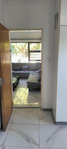 a view of a living room with a couch through a door at 15 on 11th Summerstrand in Summerstrand
